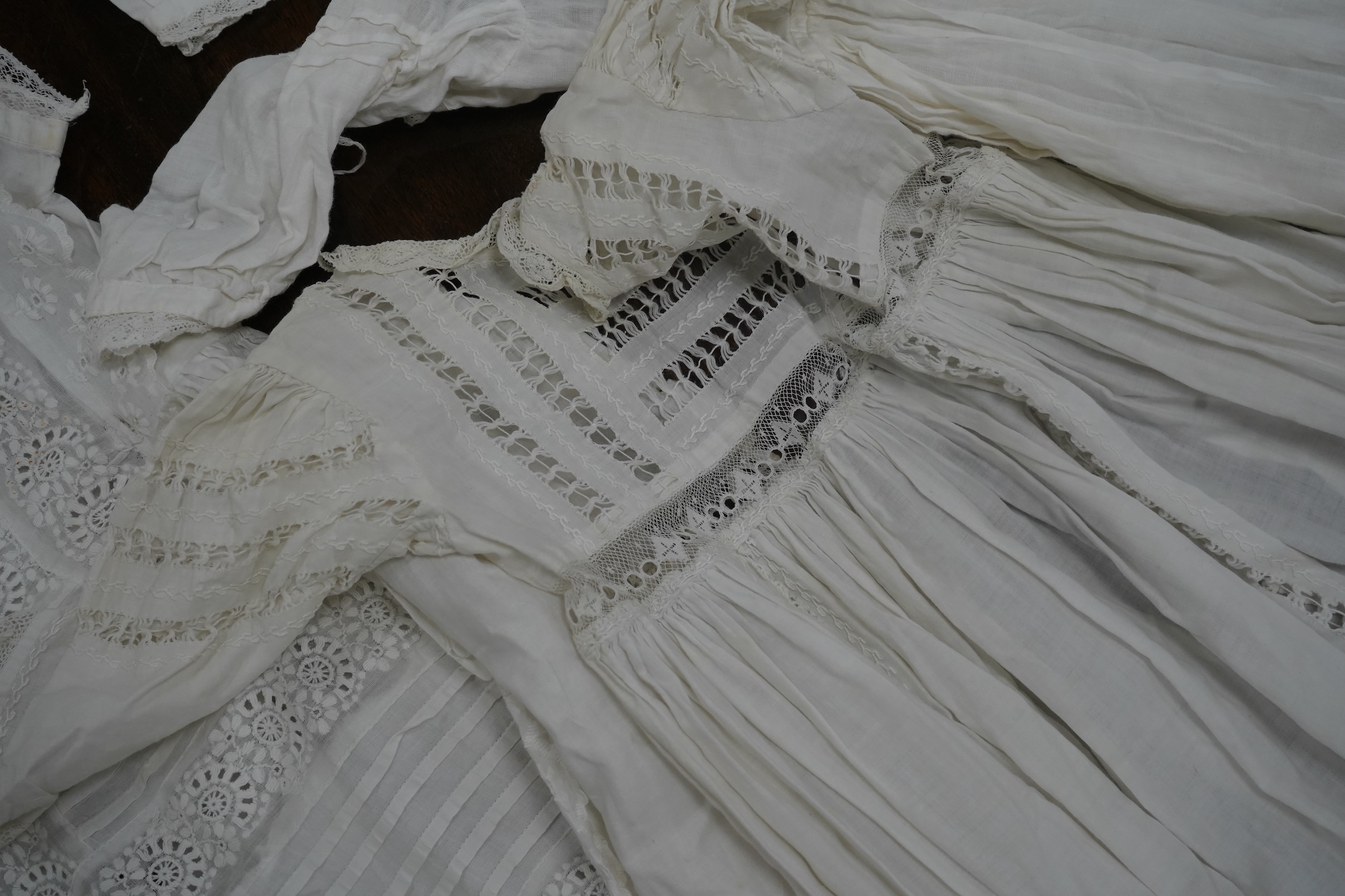 Five Victorian white worked fine cotton and lawn baby’s christening gowns. mostly worked with embroidery anglaise, feather stitching, tucking, drawn thread work and lace edging, longest 41cm. Condition - in good conditio